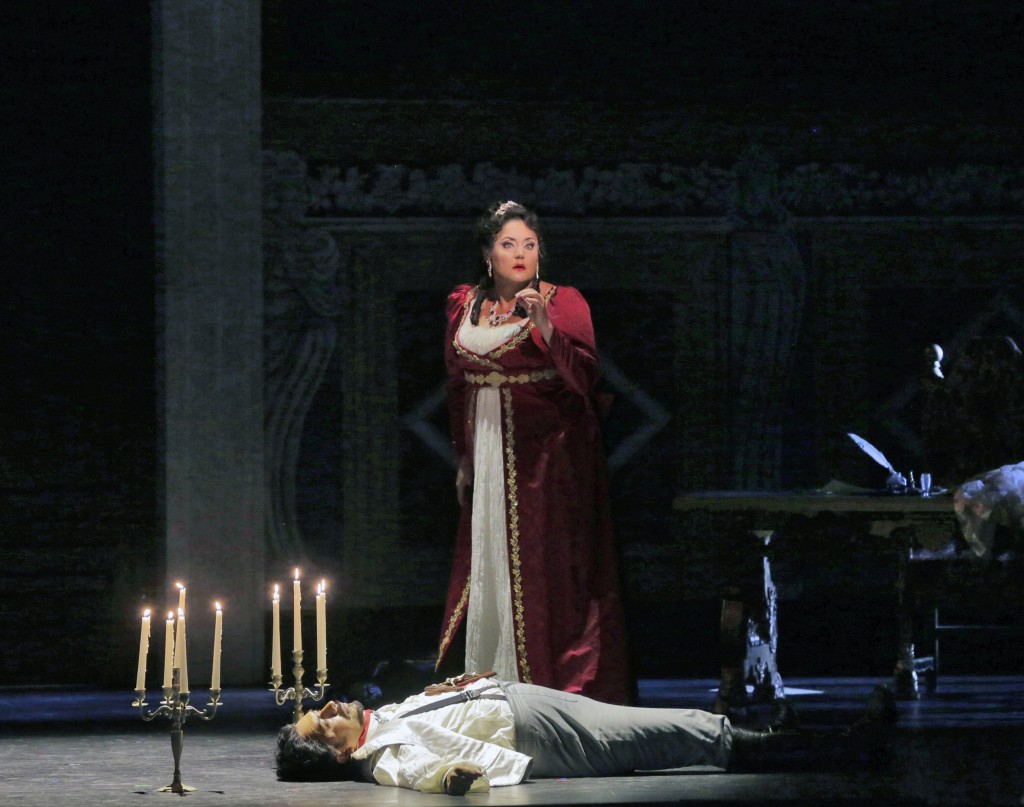 Tosca (Kara Shay Thomson) stands over the body of Scarpia (Luis Ledesma). Photo by Ken Howard